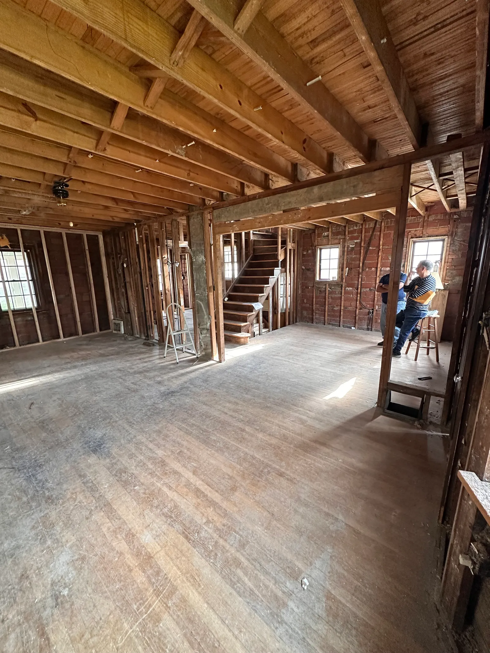 Open interior showing exposed wood framing and joist structure