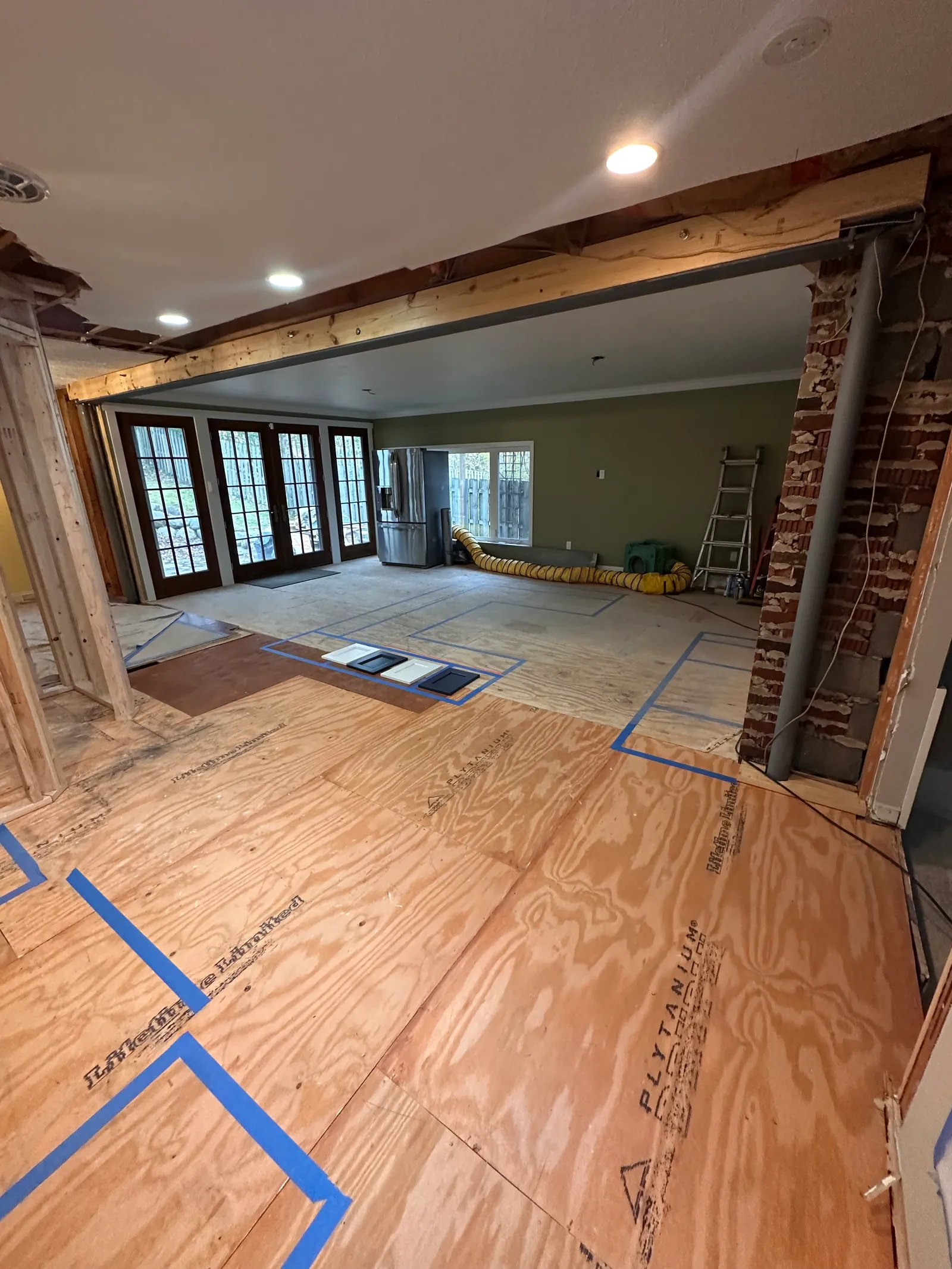 Interior structural renovation with new subflooring and exposed beam work