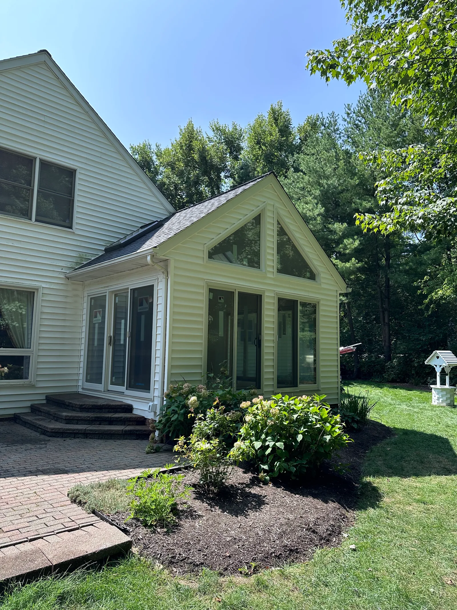 Interior of room addition with exposed wall framing and roof trusses