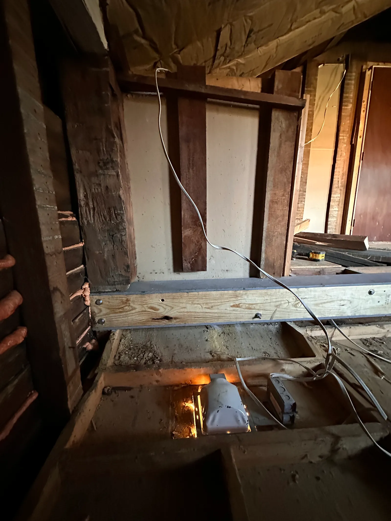 Close-up of steel beam bolted to pressure-treated lumber connection point