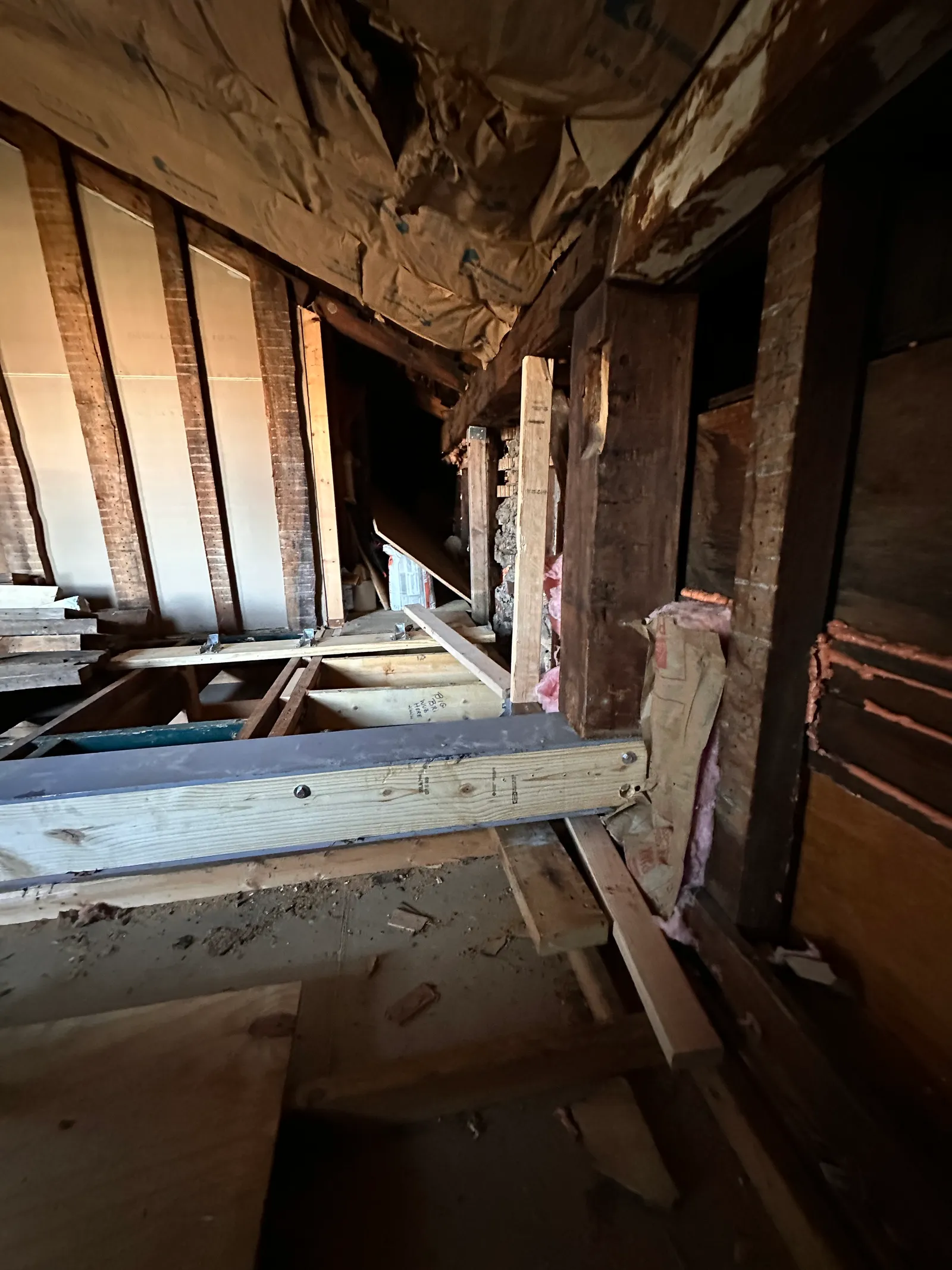 Steel beam connected to ledger with surrounding wall framing and insulation