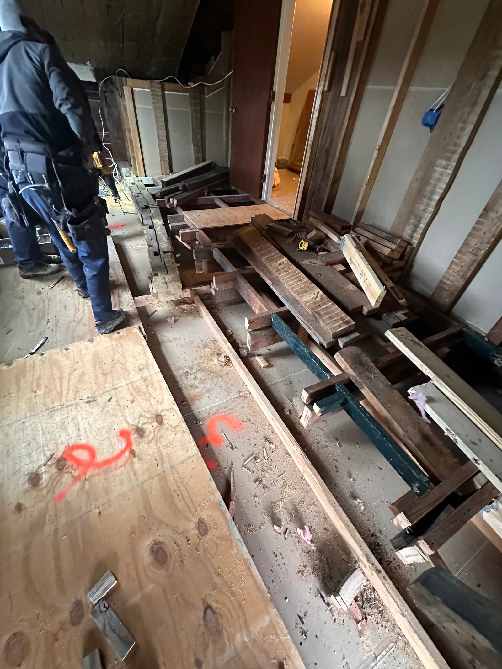 Steel beam with new sistered lumber reinforcing existing floor joists