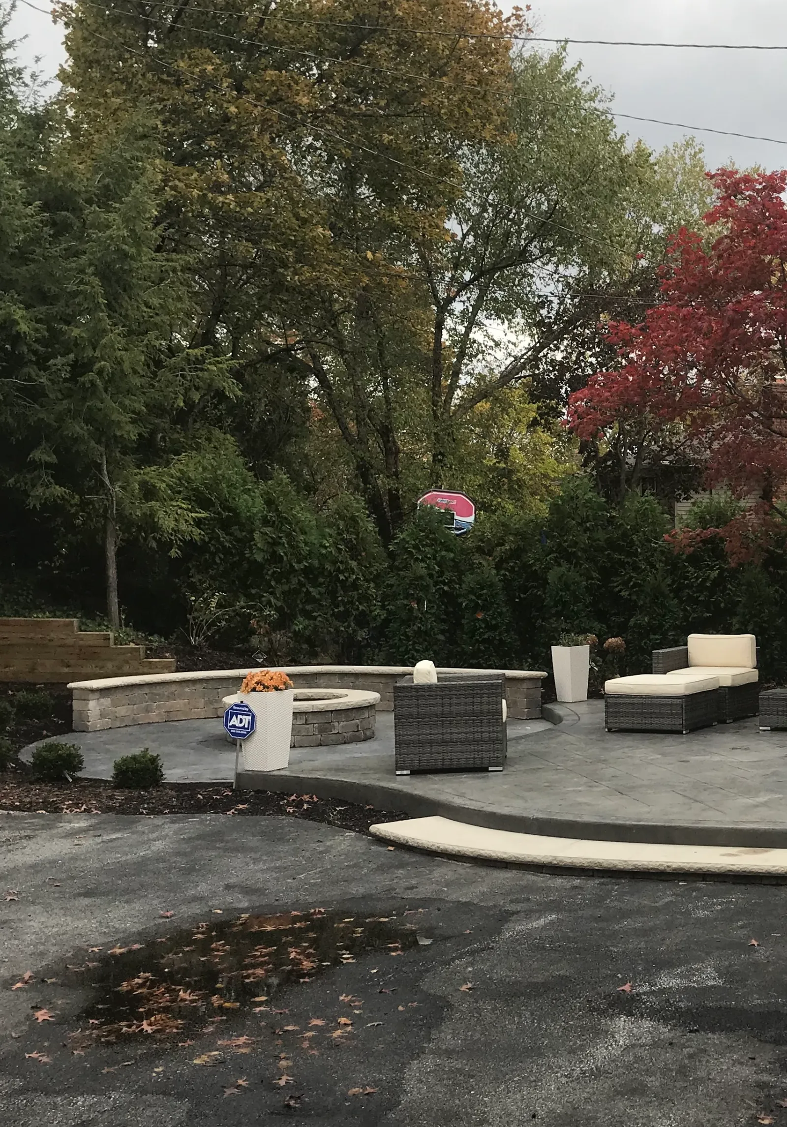Completed stamped concrete patio with stone fire pit and seating wall