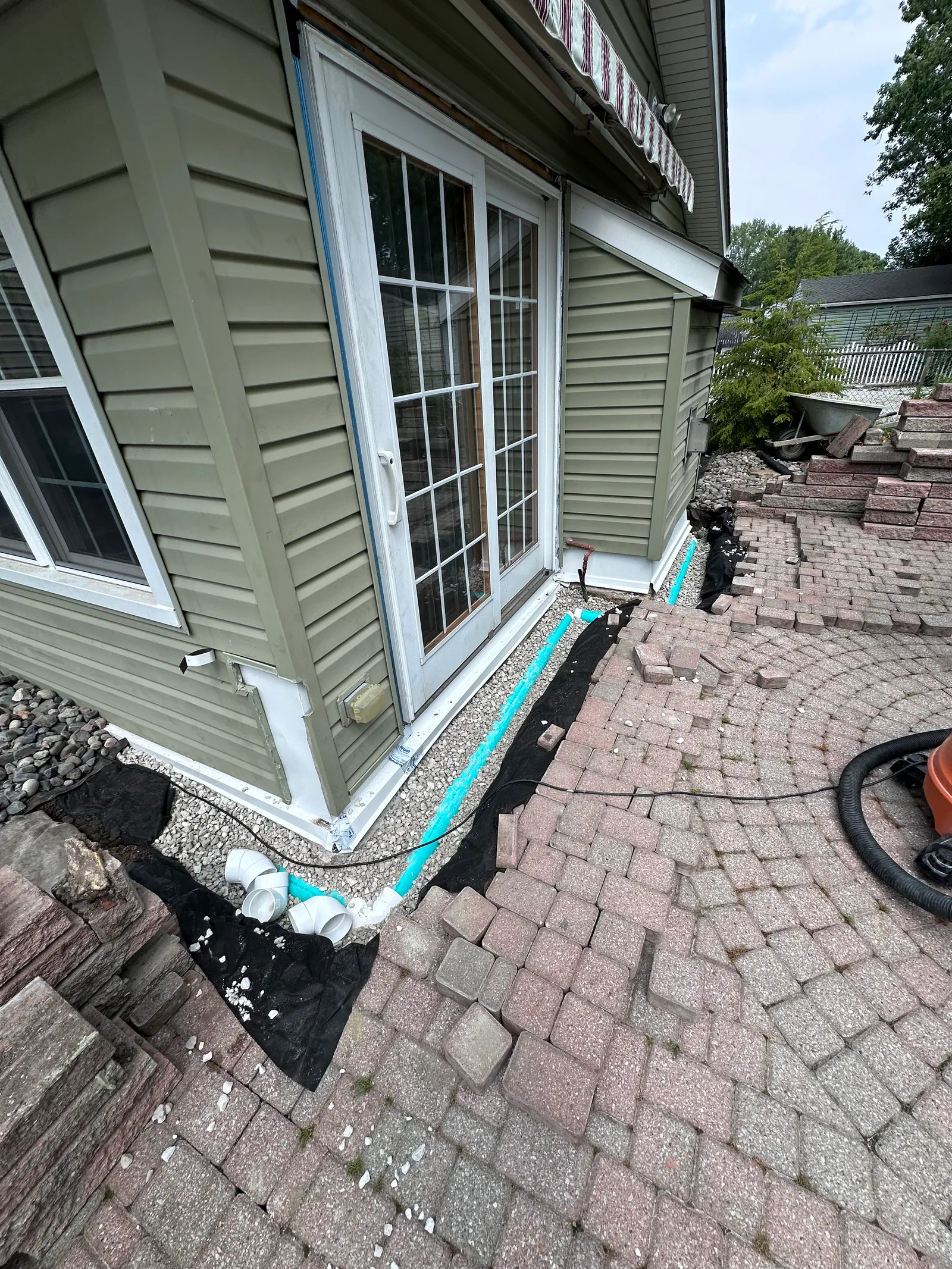 PVC drain pipe with landscape fabric along foundation perimeter