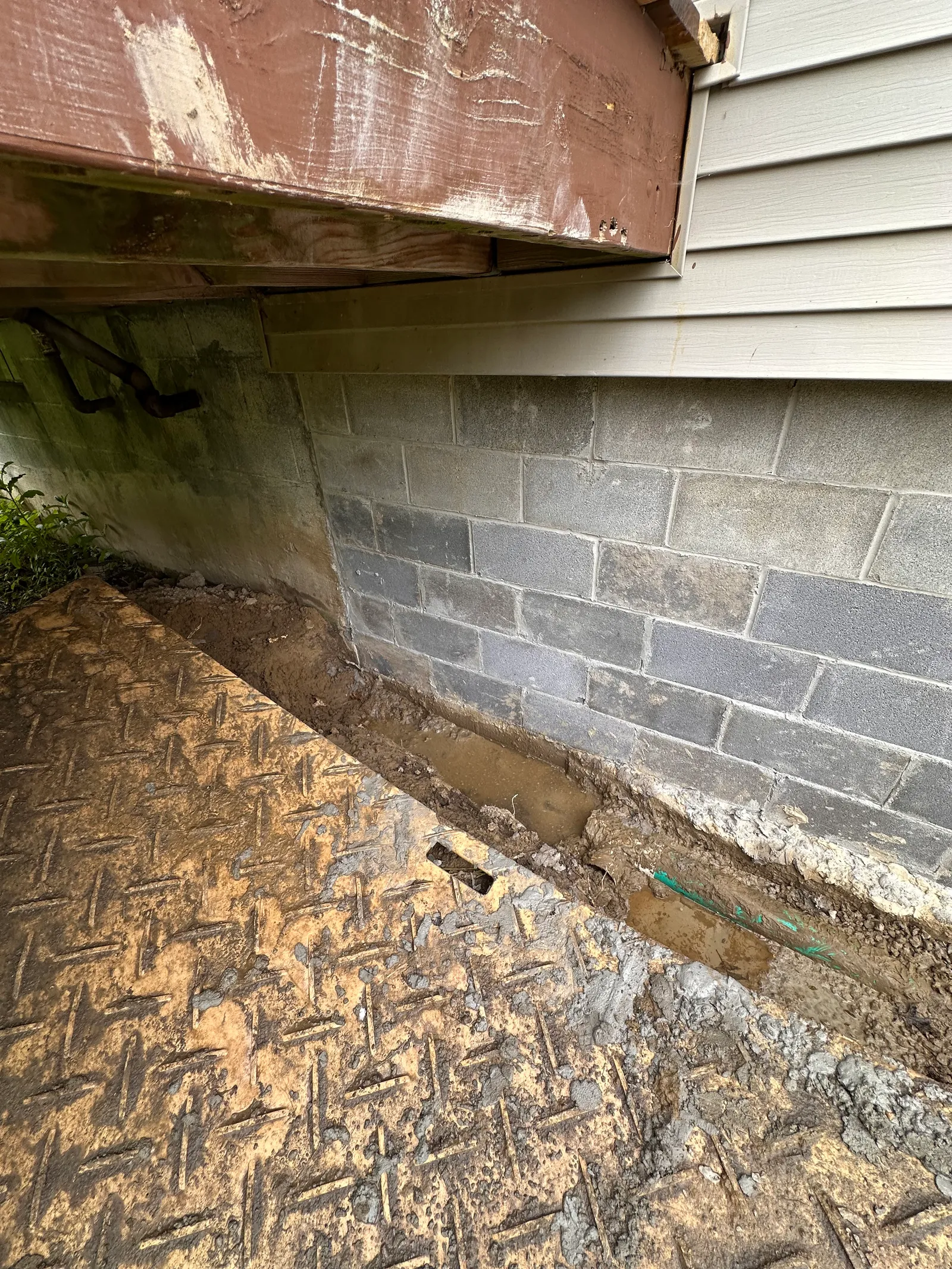 Close-up of new block wall tied into existing foundation structure
