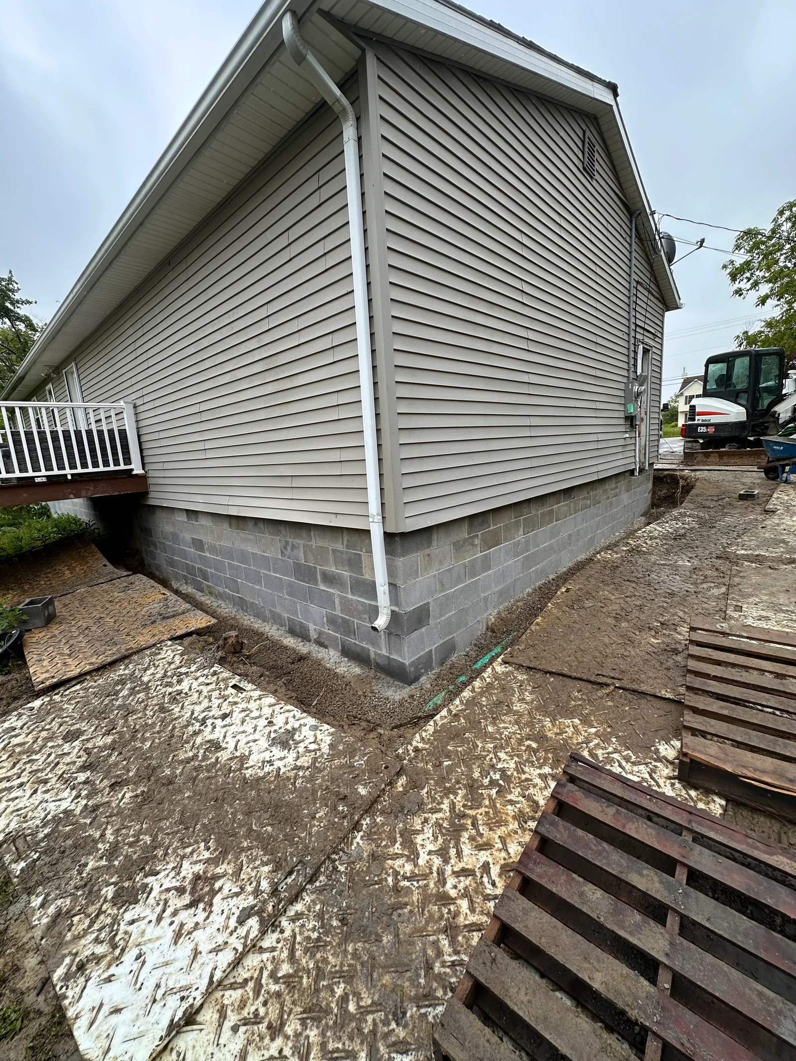 New foundation block wall wrapping around corner of residential structure