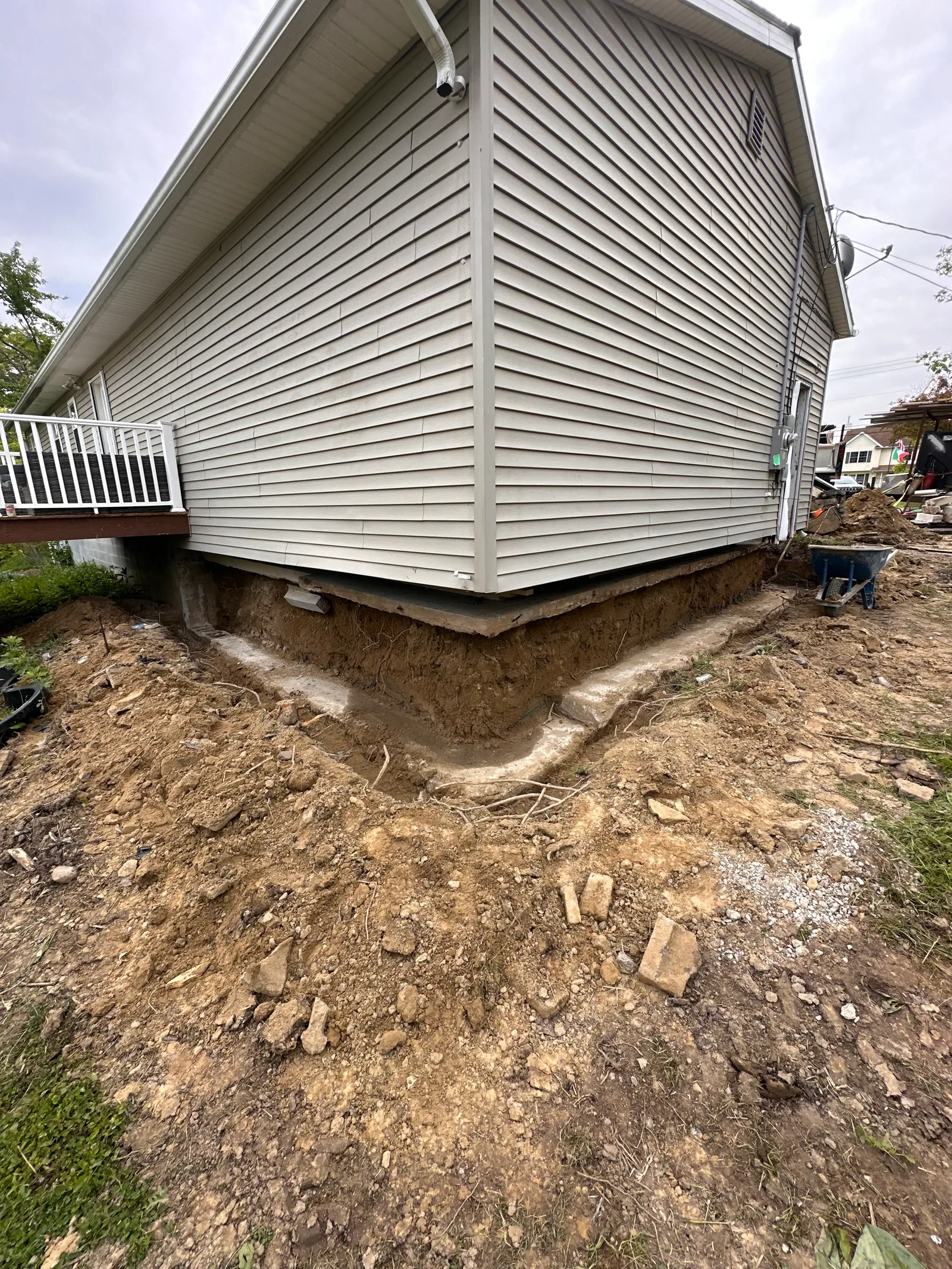 Foundation perimeter fully excavated exposing wall and footing for repair