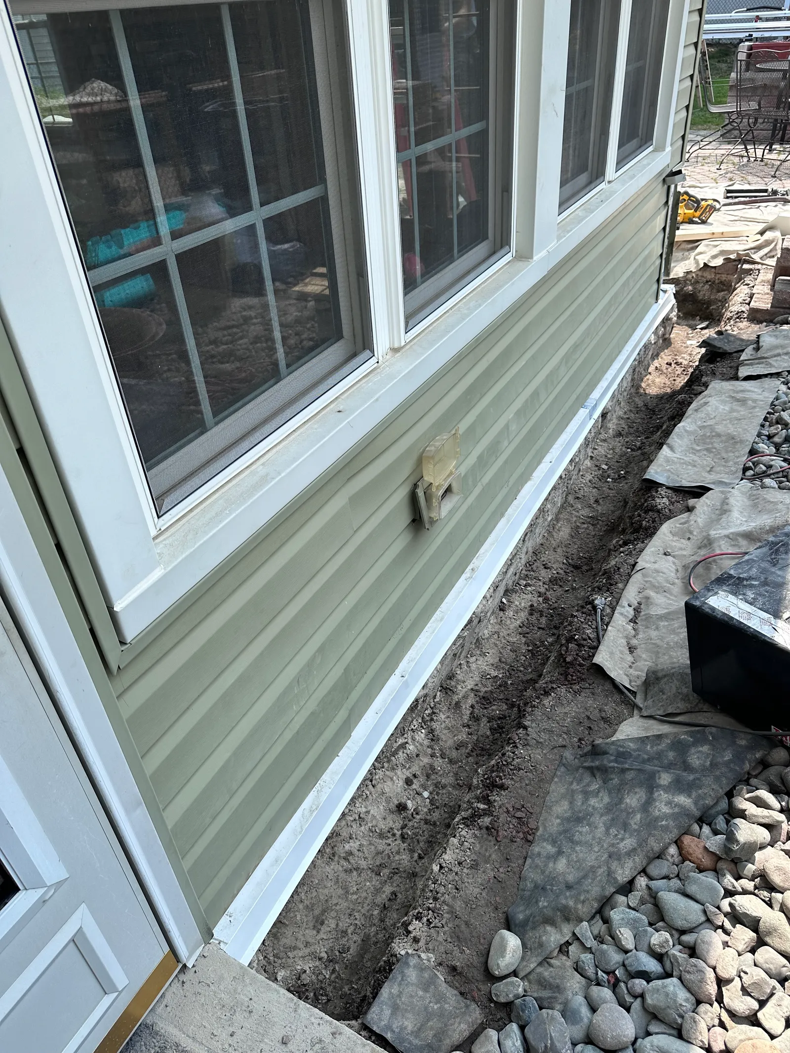 Foundation perimeter trench with gravel drainage bed during repair