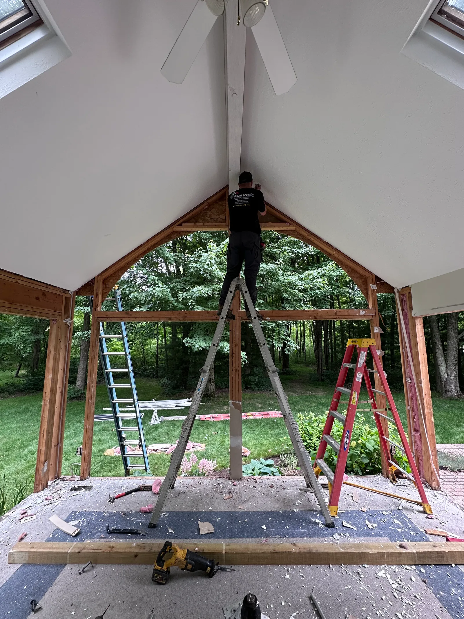 Crew working on structural opening with framing and power tools