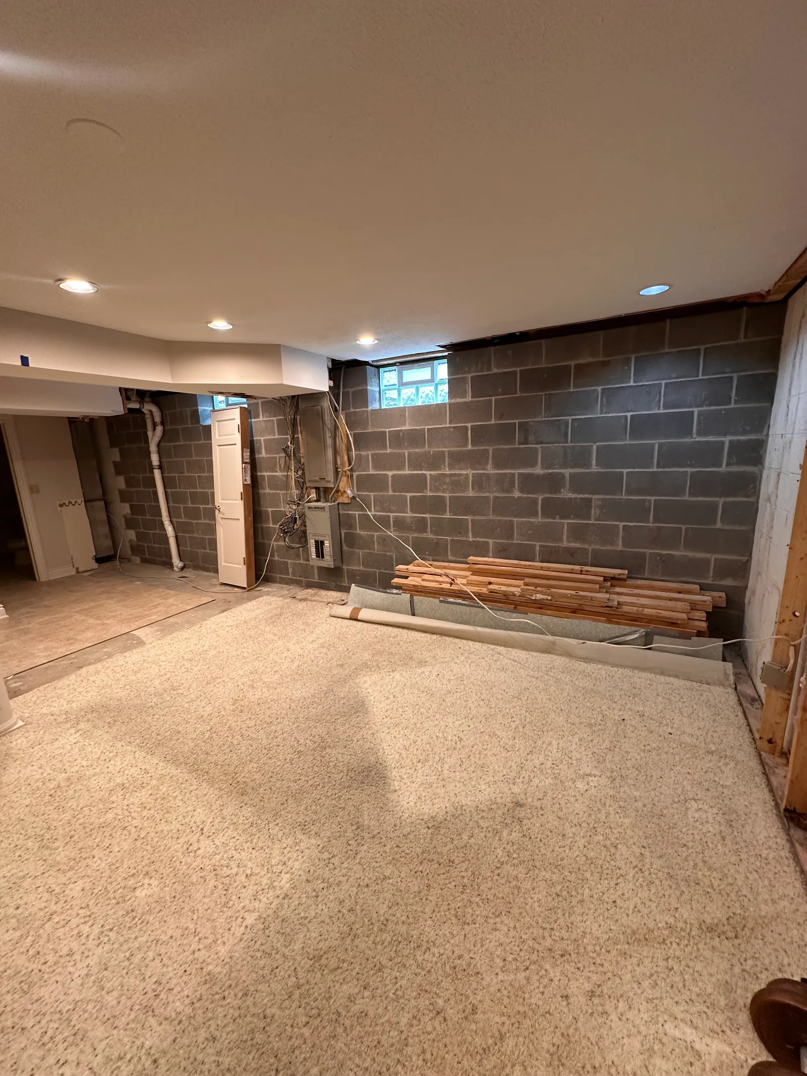 Basement interior with drywall stripped to expose CMU block walls for stabilization