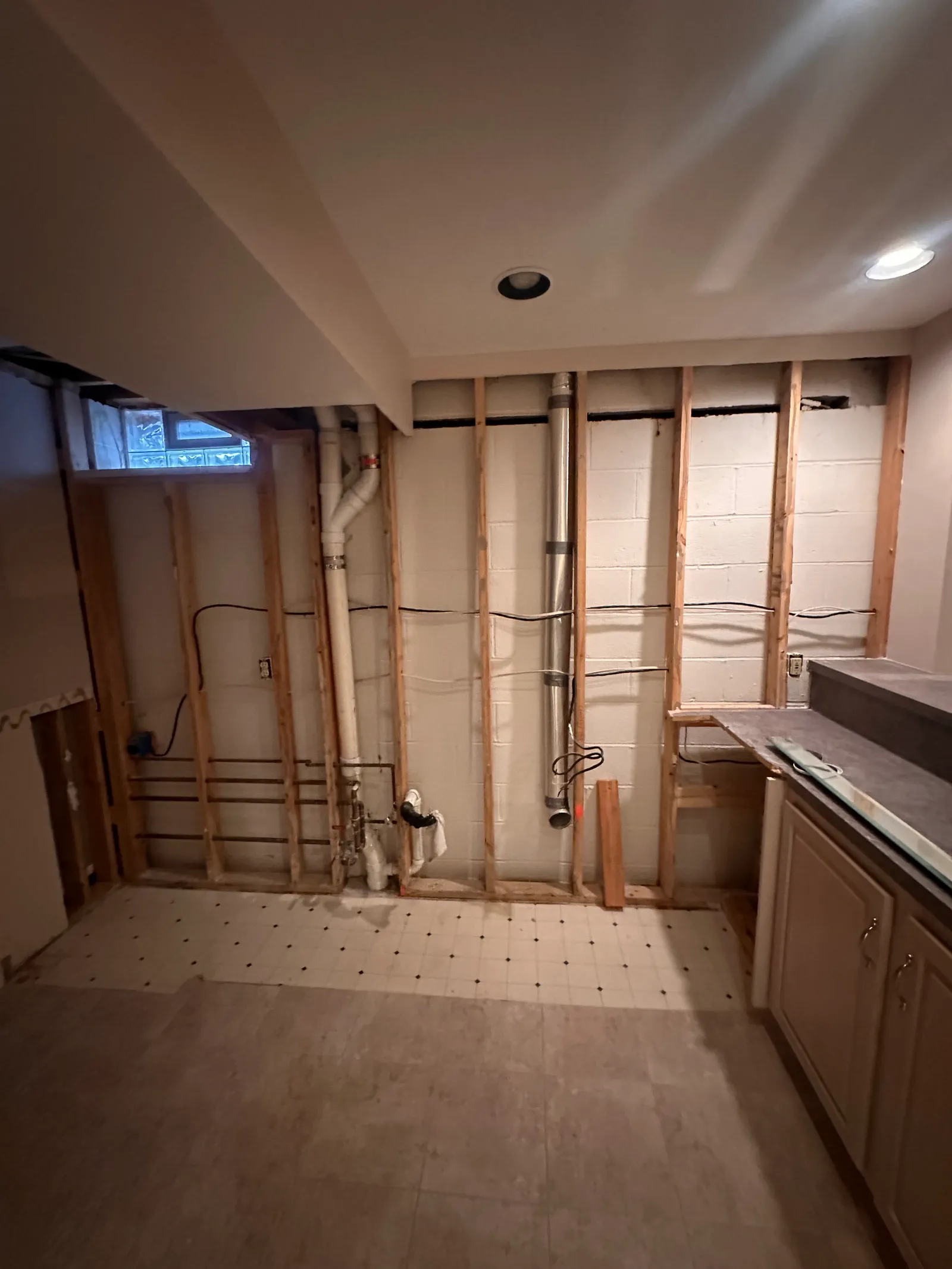 Basement with walls stripped to expose cracking in foundation block walls