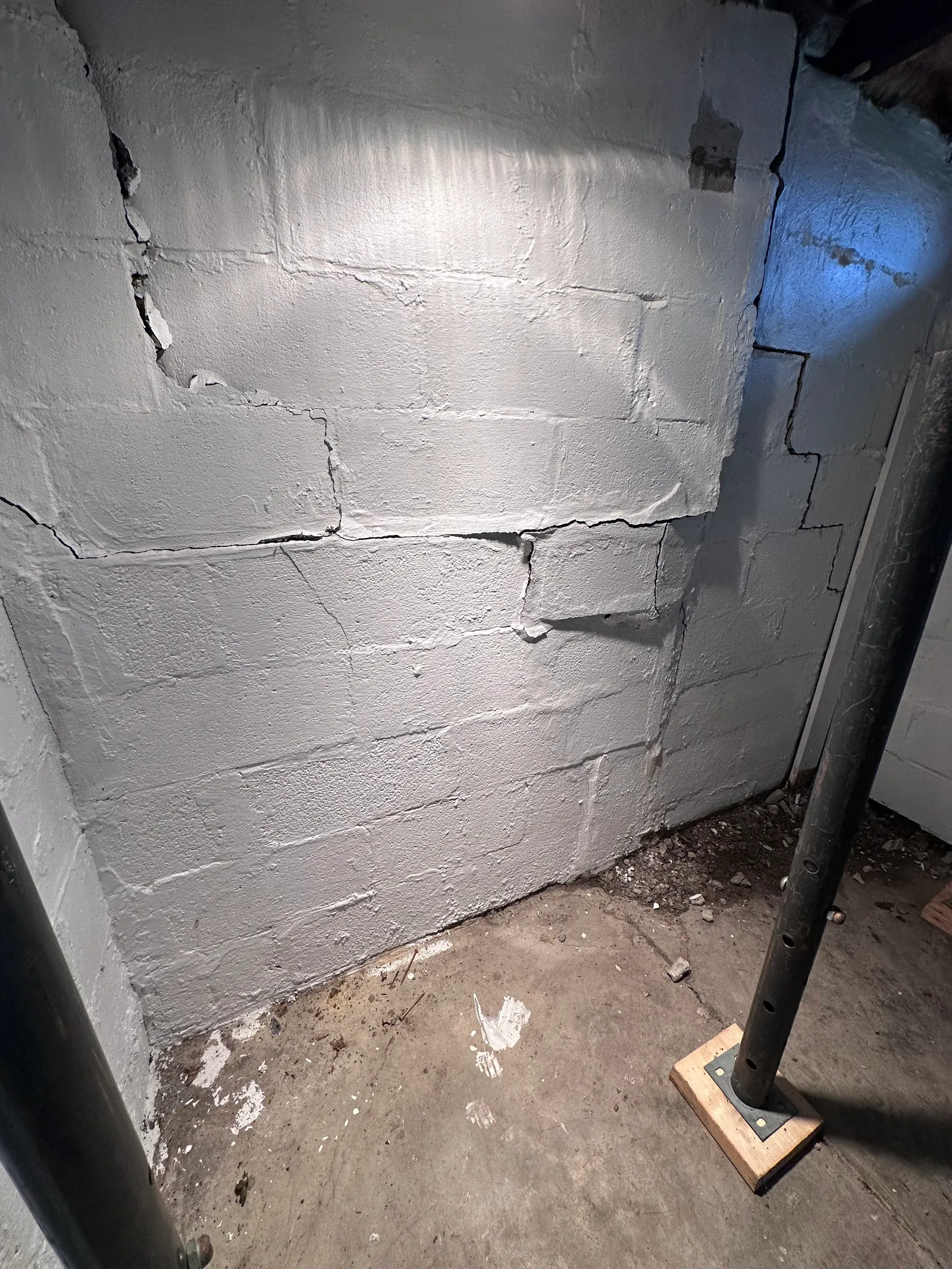 Basement wall crack repair with steel brace and bearing plates in Cleveland